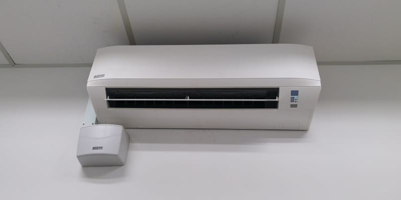 Air conditioner unit with attached voltage stabilizer, illustrating protection against voltage fluctuations.