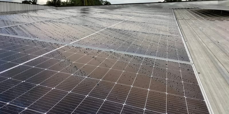 Rain droplets on a solar panel during the rainy season.