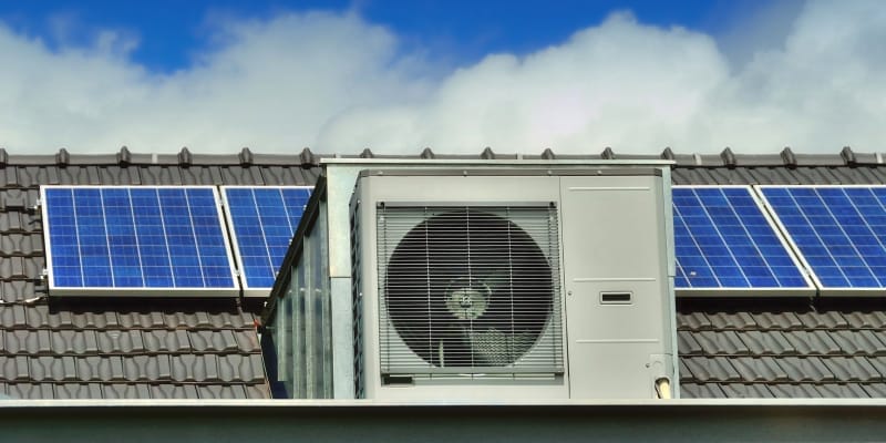 AC outlet powered by solar panel system, illustrating how solar energy can reduce air conditioner electricity costs during summer.